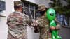 Staff Sgt. James Taylor enlisted into Space Force  at the Presidio of Monterey along with Buddy, the alien mascot, who also participated in the event, keeping an eye on the guests, Feb. 11, 2020. (Twitter / DLIFLC)