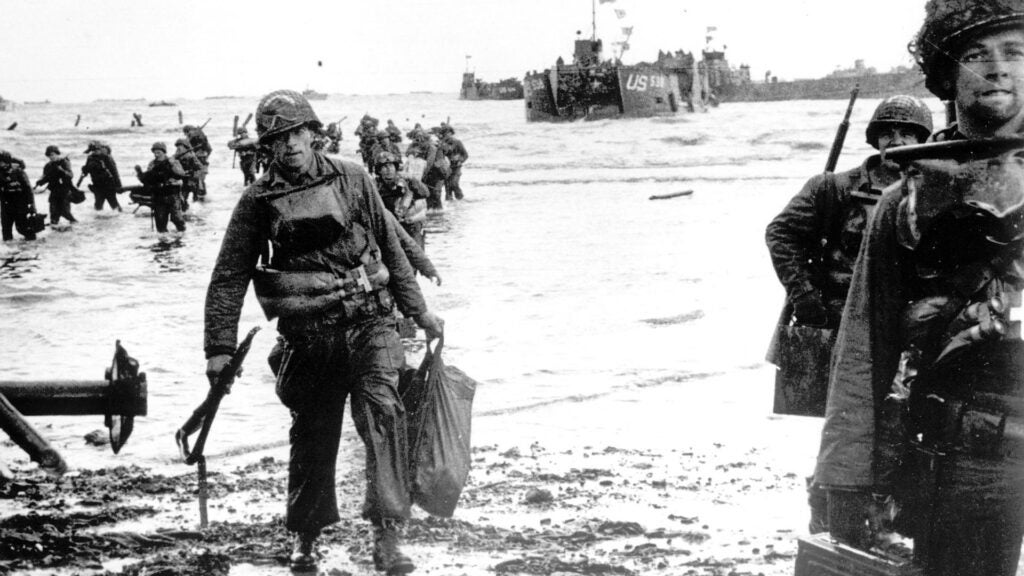 Carrying full equipment, American assault troops move onto a beachhead code-named Omaha Beach, on the northern coast of France on June 6, 1944, during the Allied invasion of the Normandy coast. (AP Photo)