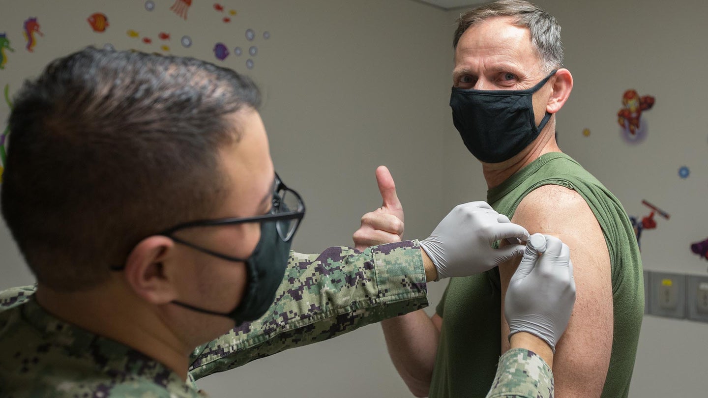 Marine Corps Air Station Cherry Point Executive Officer Lt. Col Patrick Lindstrom signals approval with a thumbs-up as he receives the first dose of the Moderna vaccine during the DoD first phase level of vaccine administration at Navy Health Clinic Cherry Point, North Carolina, Dec. 23, 2020. 