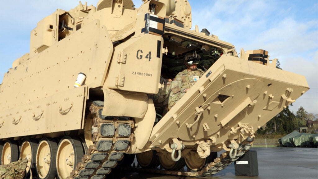 Soldiers don the Integrated Visual Augmentation System Capability Set 3 hardware while dismounting a Bradley in Joint Base Lewis-McCord, WA, Jan. 27, 2021 (Army photo / Courtney Bacon)