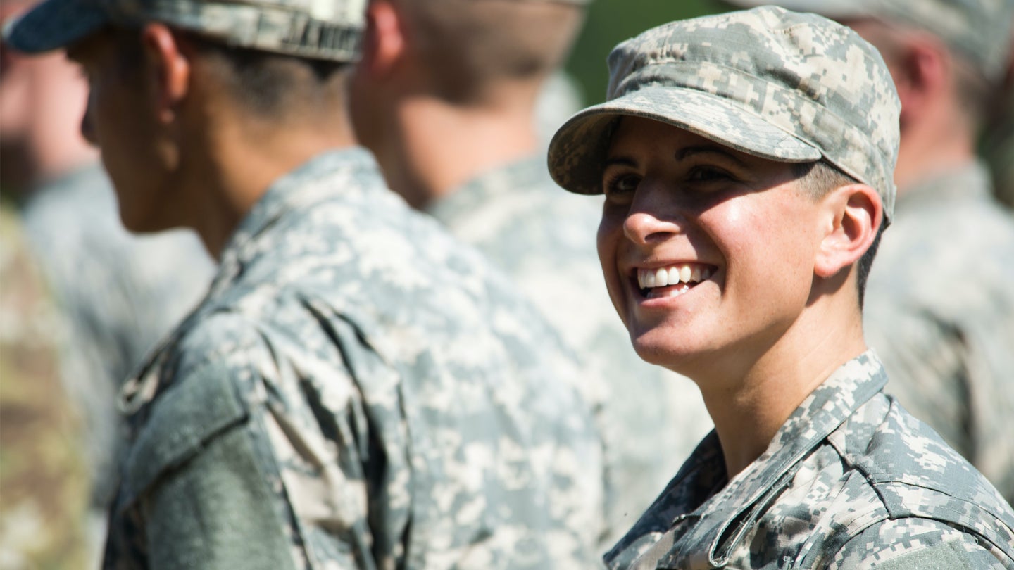 Capt. Kristen Griest smiles at friends and family as she waits with her U.S. Army Ranger School Class 08-15 to graduate at Fort Benning, Ga., Aug. 21, 2015.