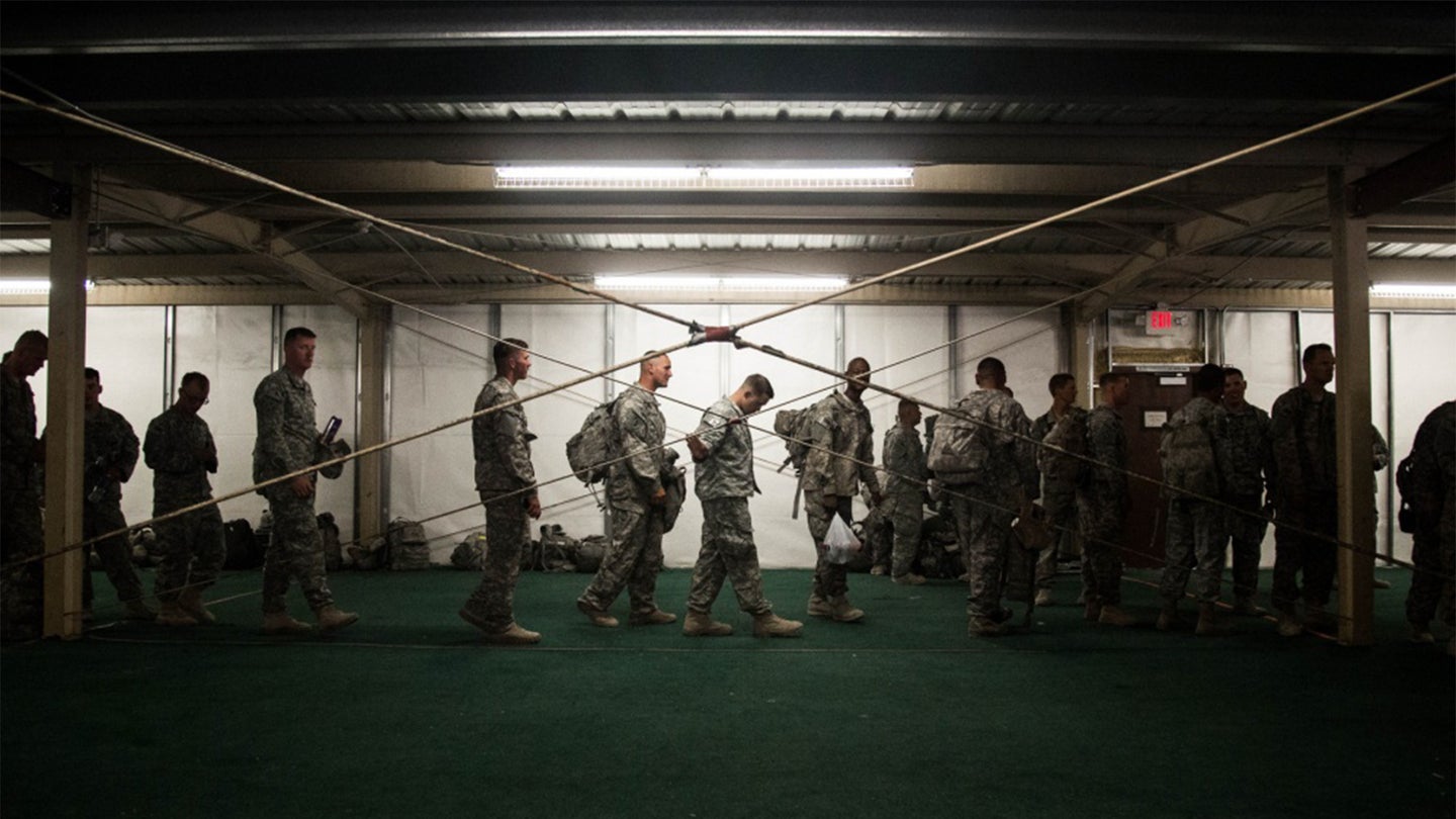 Soldiers of 2nd Armored Brigade Combat Team, 4th Infantry Division, stand in line for a pre-manifest as they prepare to leave National Training Center, Fort Irwin, Calif., July 2, 2013 (Army photo / Sgt. Marcus Fichtl)