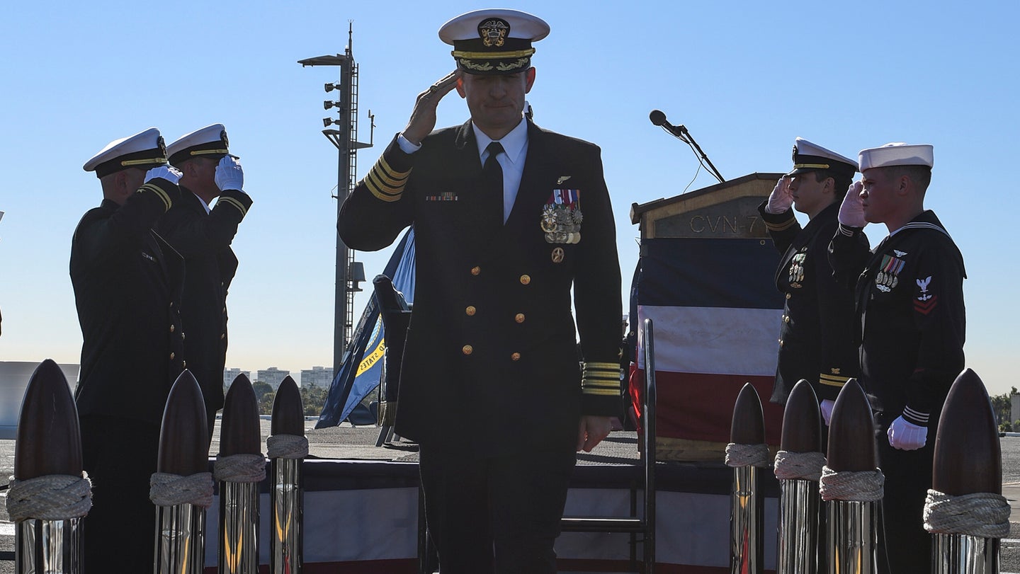 191101-N-CU072-1294 SAN DIEGO (Nov. 1, 2019) Sideboys salute Capt. Brett Crozier, commanding officer of the aircraft carrier USS Theodore Roosevelt (CVN 71), during a change of command ceremony on the ship’s flight deck. Crozier relieved Capt. Carlos Sardiello to become the 16th commanding officer of Theodore Roosevelt. (U.S. Navy photo by Mass Communication Specialist 3rd Class Sean Lynch/Released)