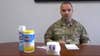 Chief Master Sgt. James Lyda gives a daily update alongside one of the earlier forms of Scott the toilet paper roll. (Screenshot via Facebook vide)
