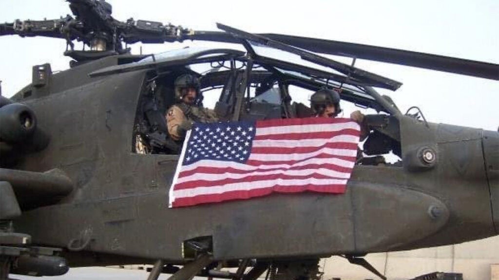 Chief Warrant Officer 3 Rich Adams and 1st Lt. Ernie Carlson pictured aboard their Apache helicopter in 2006 (Courtesy photo).
