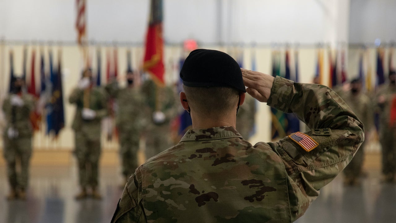 Outgoing commander of 2nd Battalion, 17th Field Artillery Regiment, 2nd Stryker Brigade Combat Team, 7th Infantry Division, salutes the colors as the national anthem plays during a change of command ceremony. (U.S. Army/Pvt. Dean Johnson)