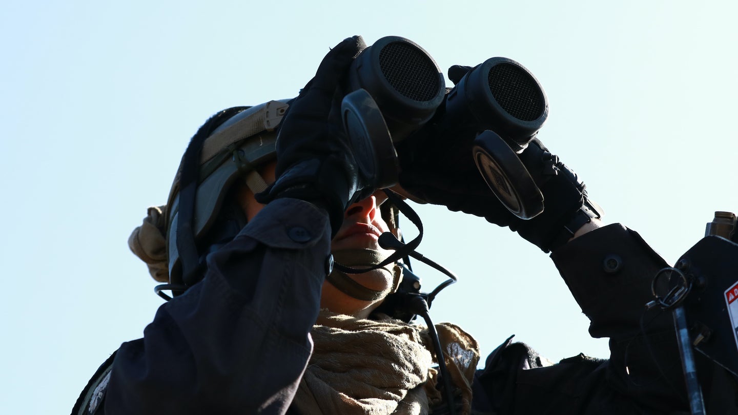 A U.S. Army Soldier assigned to the 1st Battalion, 4th Infantry Regiment, looks through his binoculars during Combined Resolve XV at Hohenfels Training Area, Germany, Feb. 28, 2021. Combined Resolve XV allows allies and partners to connect - personally, professionally, technically, and tactically – to create stronger, more capable forces during times of crisis. (U.S. Army photo by SSG Thomas Stubblefield)