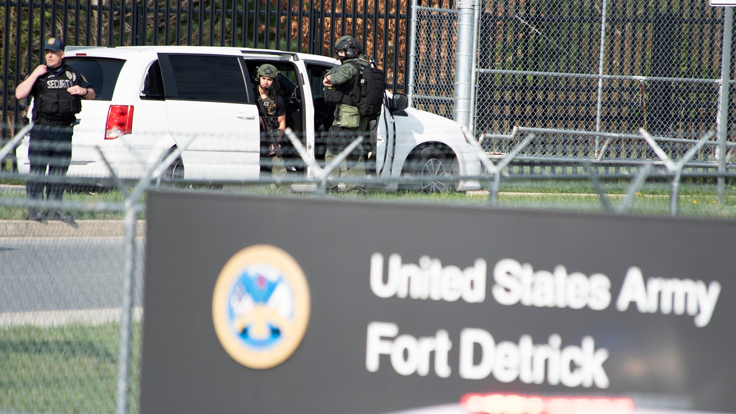 Members of the Frederick Police Department Special Response Team prepare to enter Fort Detrick at the Nallin Farm Gate in a convoy of vans and sedans, following a shooting in the Riverside Tech Park, near the Royal Farms on Monocacy Boulevard, Tuesday morning, April 6, 2021, in northeast Frederick, Md. Authorities say a Navy medic shot and critically wounded two people at a Maryland business park before fleeing to the Fort Detrick Army base, where he was shot and killed.