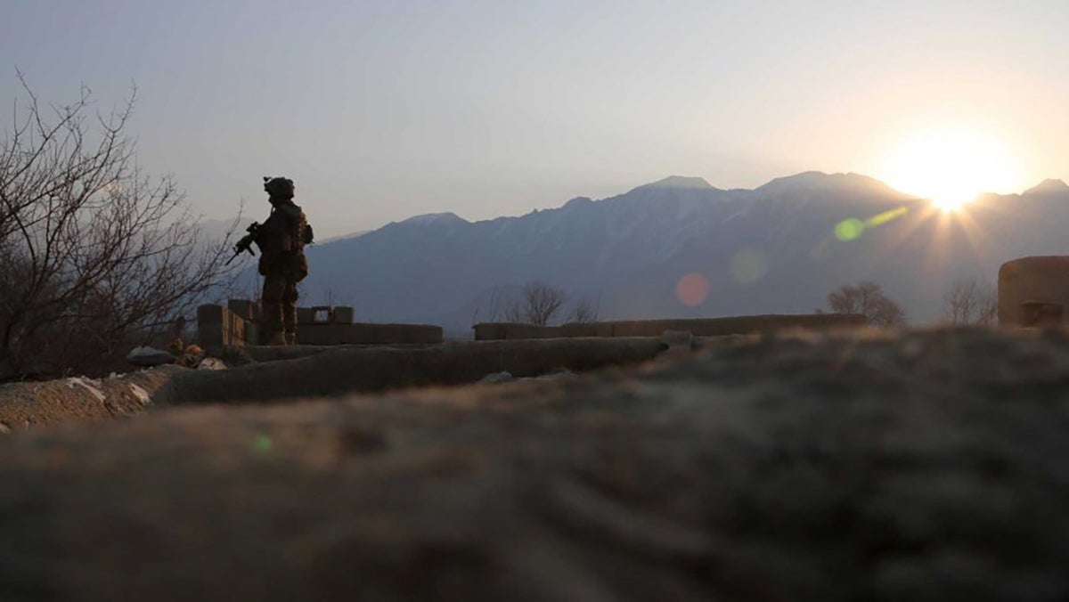 An Afghan National Army commando with the 6th Special Operations Kandak guards a rooftop during morning operations in Tagab District, Kapisa Province, Afghanistan, in February 2013. (U.S. Army photo by Pfc. James K. McCann.)