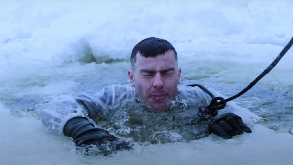 A British soldier from the 5 RIFLES infantry battalion goes through cold water immersion during Exercise Winter Camp, Estonia, February, 2021 (Screenshot via YouTube / NATO)