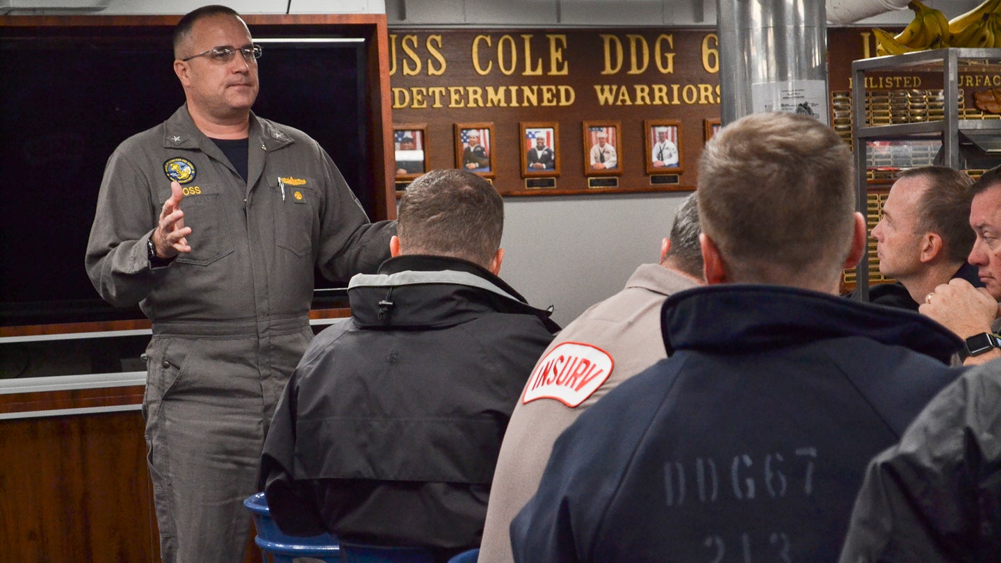 171205-N-IR859-026 ATLANTIC OCEAN (Dec. 5, 2017) Rear Adm. Erik Ross, Board of Inspection and Survey (INSURV), speaks to Sailors and inspectors during a brief aboard USS Cole (DDG 67). Cole is underway conducting INSURV, which is a periodic inspection to ensure the ship meets Navy standards. (U.S. Navy photo by Chief Mass Communication Specialist Jen Blake/Released)