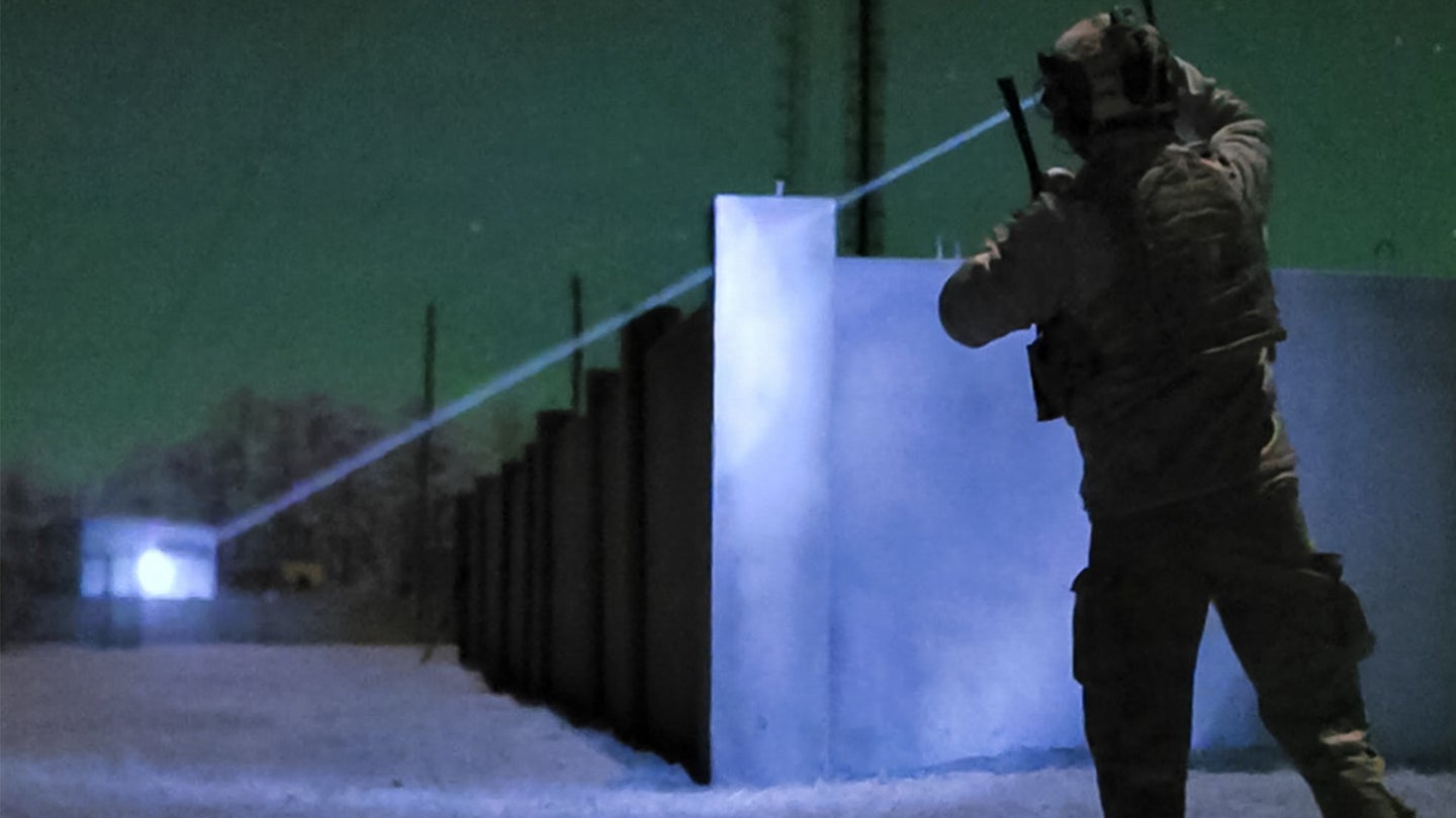 A U.S. Air Force Special Tactics operator assigned to the 24th Special Operations Wing marks a target with an infrared laser during Emerald Warrior 21.1, Feb. 22, 2021, at Camp Shelby, Mississippi. (Air Force photo by Staff Sgt. Gabriel Macdonald)
