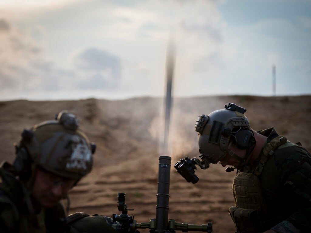 U.S. Marine Corps Raiders with the 3d Marine Raider Battalion fire an M224 mortar at Eglin Range, Fla., May 22, 2018. The 1st Special Operations Support Squadron Operations Support Joint Office coordinates two-week training programs for U.S. Army, Navy and Marine special operations forces that provides live-fire ranges and familiarizes them with Air Force Special Operations Command assets to ensure global readiness. (U.S. Air Force photo by Senior Airman Joseph Pick) (Portions of this image were obscured for security reasons)