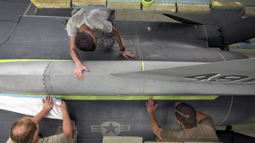 Airmen from the 49th Equipment Maintenance Squadron Corrosion Control Paint Barn complete a custom paint scheme for the 49th Wing F-16 Fighting Falcon Flagship on Holloman Air Force Base, N.M. The process consists of sanding, priming, stenciling, and painting along with any finishing touches. (U.S. Air Force photo by Staff Sgt. Christine Groening)