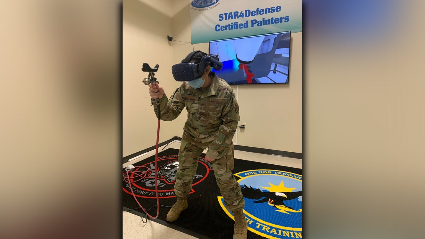 Staff Sgt. Julia Reyna, 318th Training Squadron Structures and Corrosion Instructor, uses the paint simulator during a demonstration at Joint Base San Antonio, Lackland, Texas, April 28, 2021. The newly acquired software allows mobile training teams to travel with the equipment and provide instruction to partner nation members with real-time results while eliminating expenses. (U.S. Air Force photo by Vanessa R. Adame)