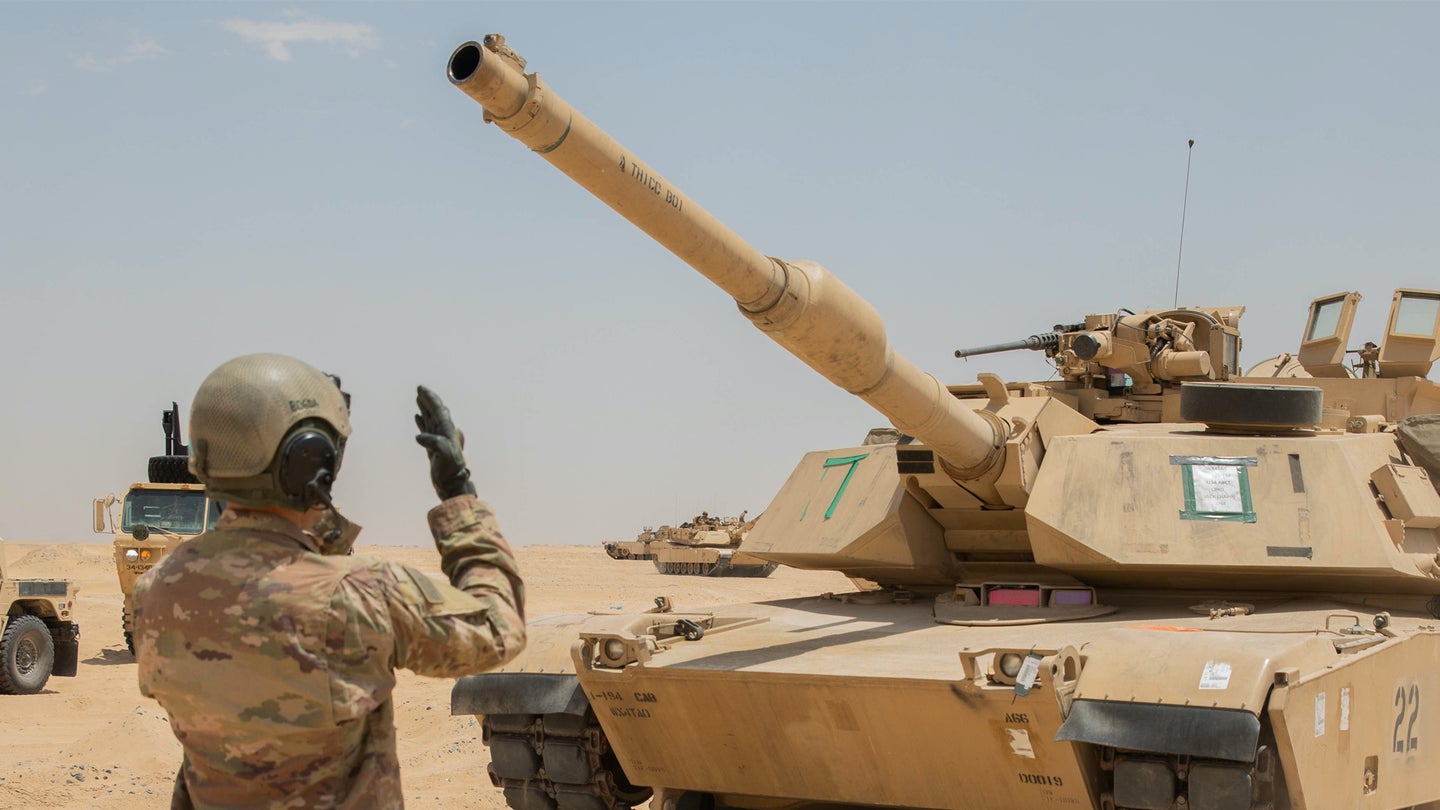 U.S. Army Capt. Michael Bogda, team commander, 1st Battalion, 194th Armor Regiment,1st Brigade Combat Team, 34th Infantry Division, directs an M1 Abrams Tank to the ammo point at Udairi Range, Kuwait, May 3, 2021. (U.S. Army/Spc. Juan Carlos Izquierdo)