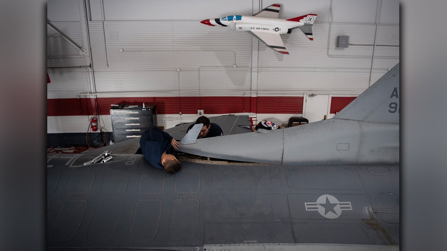 Maintainers work to convert an operational F-16 into a Thunderbird aerial demonstration jet at Nellis Air Force Base (Air Force photo)
