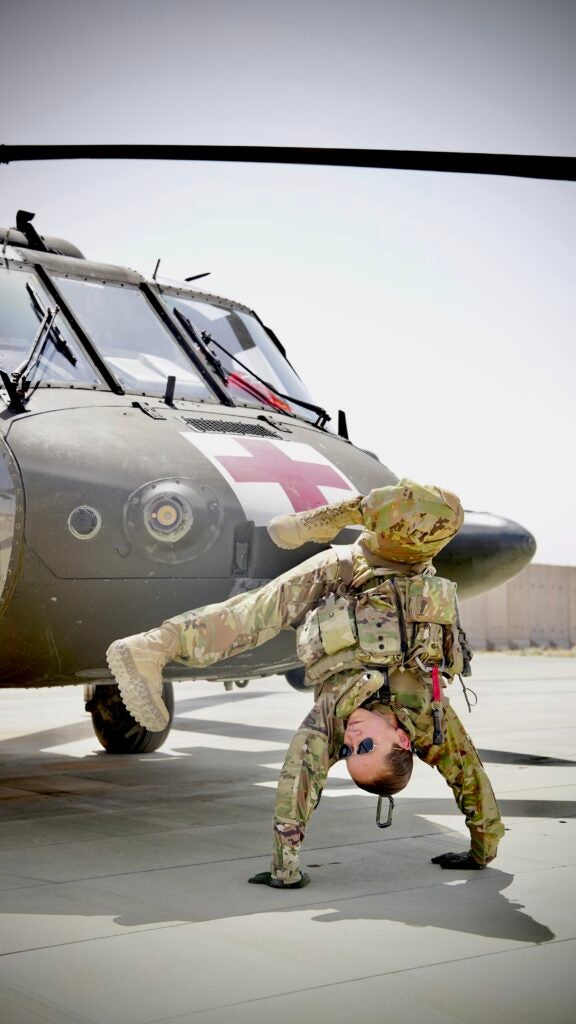 Staff Sgt. Brianna Pritchard, an Army National Guard UH-60 Black Hawk helicopter mechanic from Anchorage, Alaska, shows her Olympic breaking moves at Al Asad Air Base, Iraq. (U.S. Army National Guard photo by Sgt. Daniel Soto)
