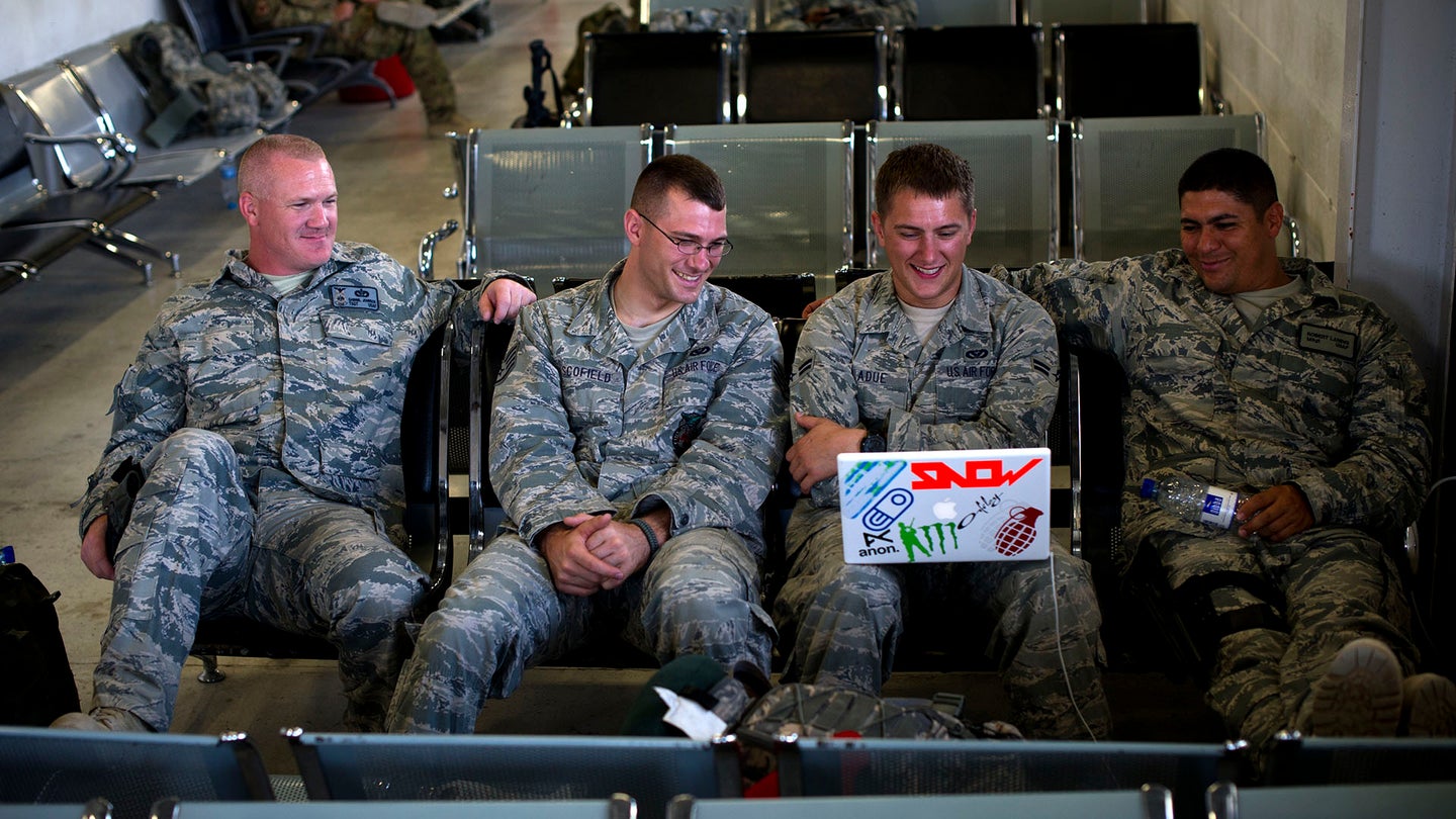 Firefighters with a quick strike team share in laughs as they watch a TV show in the Kandahar, Afghanistan passenger terminal, Aug. 11. The firefighters are part of a team, deployed to set up crass, fire and rescue at a bare base.