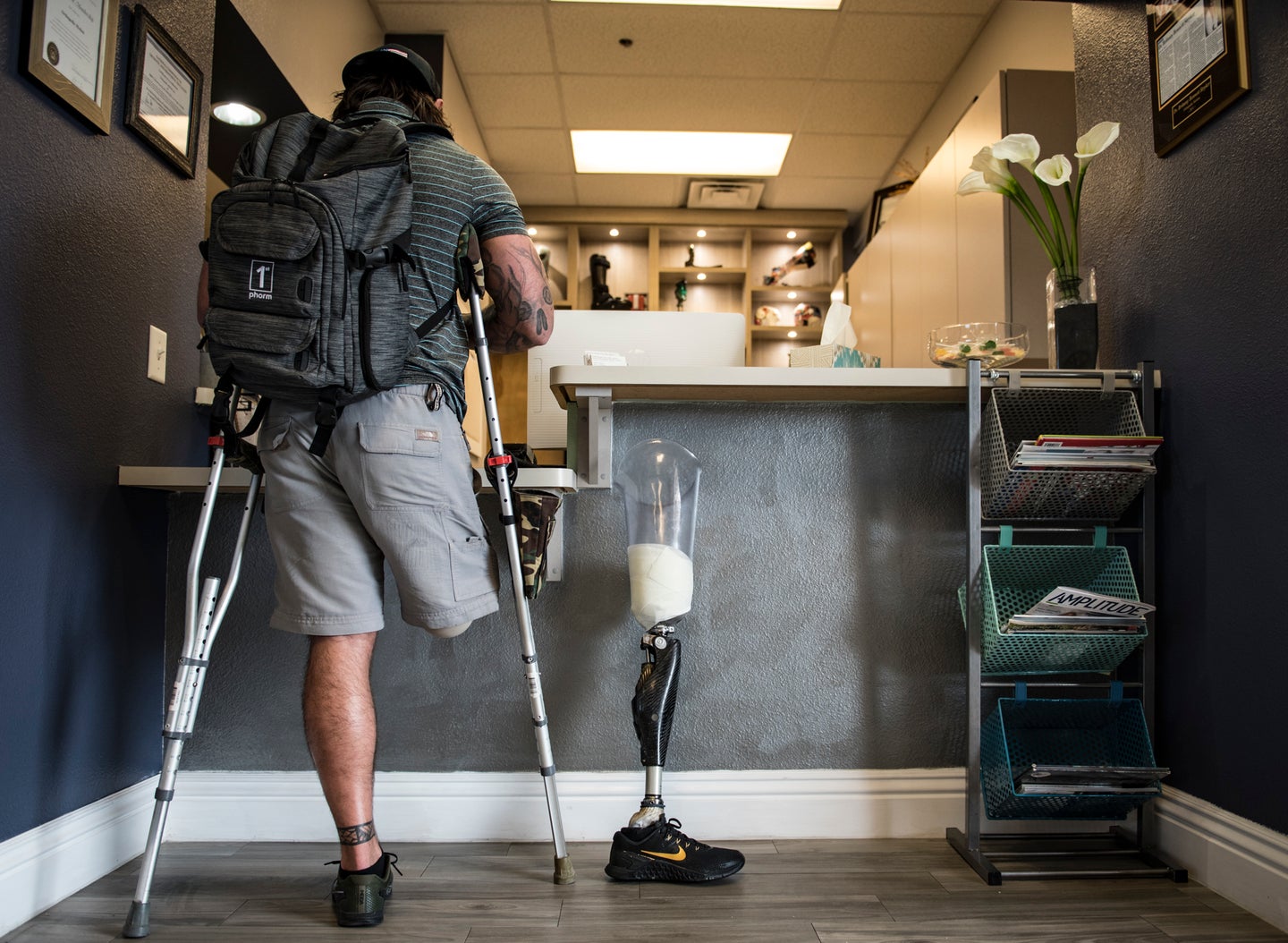 Retired U.S. Army SGT Derek Weida checks out at the front desk of a prosthetic clinic in Las Vegas April 19, 2018. Weida was fitted for a new prosthetic leg to accommodate his growing leg muscle due to weight training in the gym. (U.S. Air Force photo by Airman 1st Class Andrew D. Sarver)