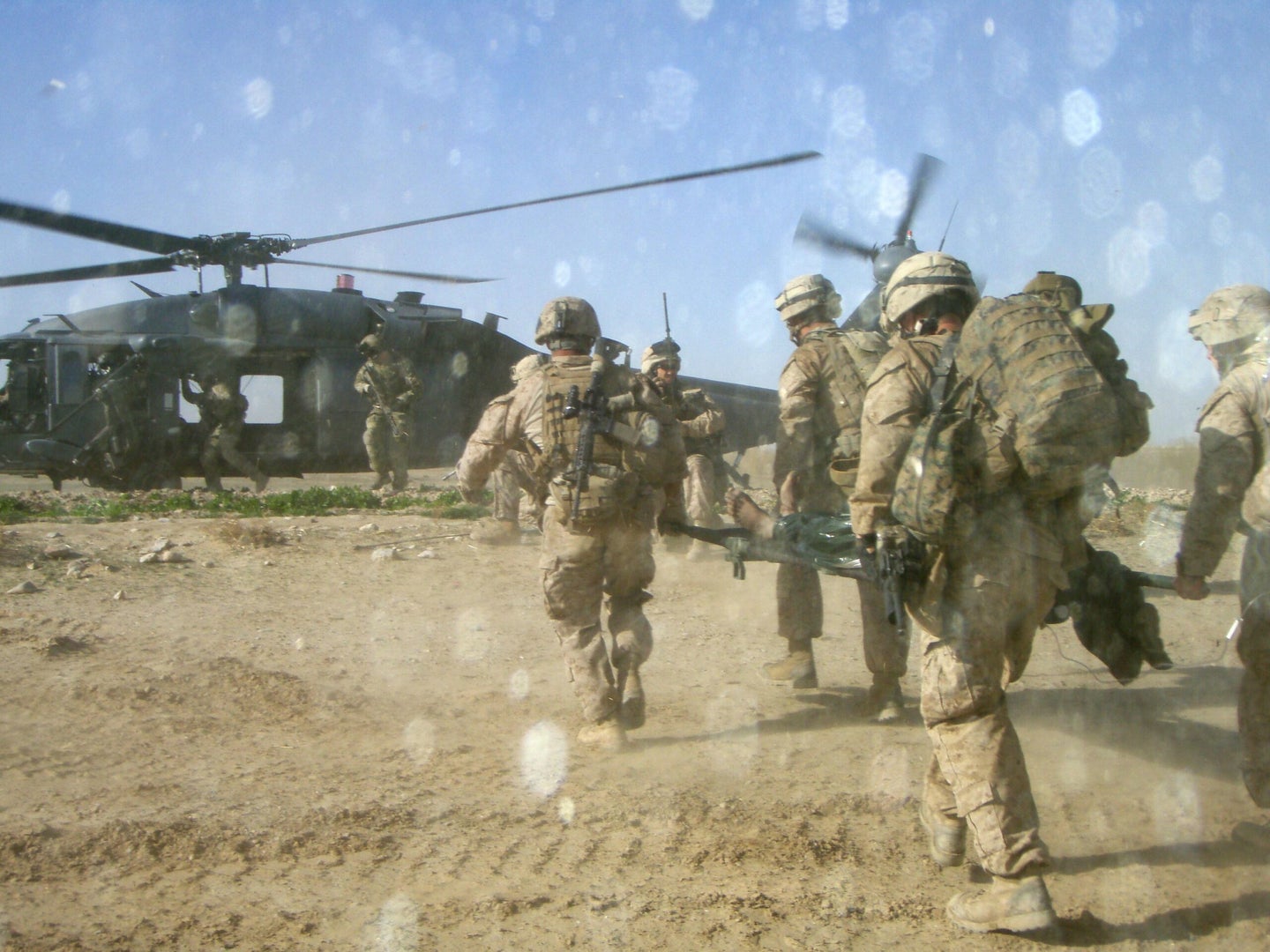 U.S. Marines and corpsmen with 3rd Platoon, Company I, Battalion Landing Team 3/8, Regimental Combat Team 8, medically evacuate Afghan civilian Ghamay Ghilgi, brought to 3rd Platoon's patrol base in Kakar village, Helmand province, Afghanistan, March 7, 2011, onto an International Security Assistance Force helicopter. Ghamay, a local farmer, was injured by an insurgency improvised explosive device. The Marines and sailors see locals approaching them for help as a positive sign of eroding support for the  insurgency. Elements of 26th Marine Expeditionary Unit deployed to Afghanistan to provide regional security in Helmand province in support of the International Security Assistance Force. (Photo by: Lance Cpl. Kevin Hassett)