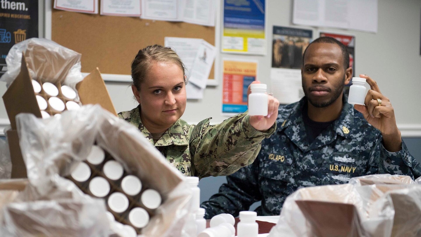 180420-N-VC599-002
NORFOLK (April 20, 2018) Information Systems Technician 2nd Class Holly Phenicie, left and Chief Yeoman Samuel Kolapo pose for a photo during a command urinalysis.  (U.S. Navy Photo Illustration by Mass Communication Specialist 2nd Class Justin Wolpert/Released)