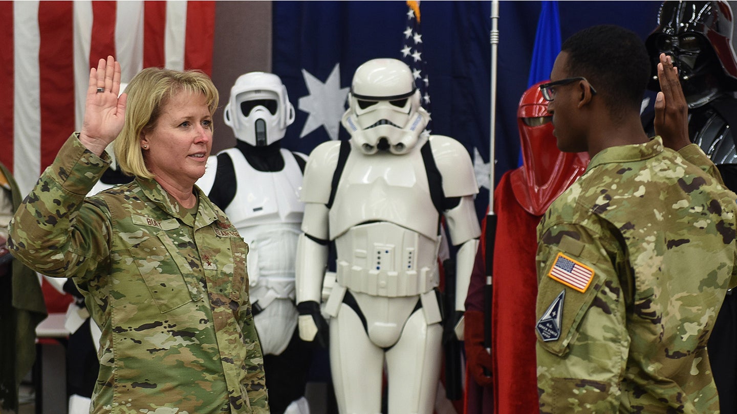 Maj. Gen. DeAnna Burt, Combined Force Space Component Command commander, is sworn in to the U.S. Space Force by Second Lt. Wellington Brookins, a U.S. Space Force officer assigned to the 533rd Training Squadron, during an International Space Day celebration May 7, 2021, Vandenberg Air Force Base, Calif. The lunchtime event for CSpOC and Combined Force Space Component Command (CFSCC) personnel included opening remarks from CSpOC/Space Delta 5 commander Col. Monique DeLauter, a rocket design and launch competition, and a cornhole tournament, followed by a brief transfer-of-service ceremony for the CFSCC commander Maj. Gen. DeAnna Burt. (U.S. Space Force photo by Michael Peterson)