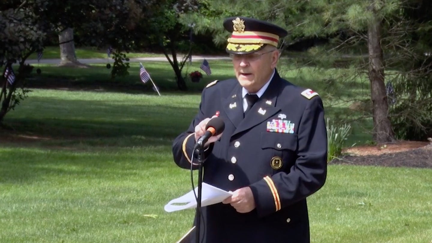Army veteran, Lt. Col. Barnard Kemter, tests his microphone during a speech at a Memorial Day ceremony in Ohio. (Screenshot from Hudson Community Television)