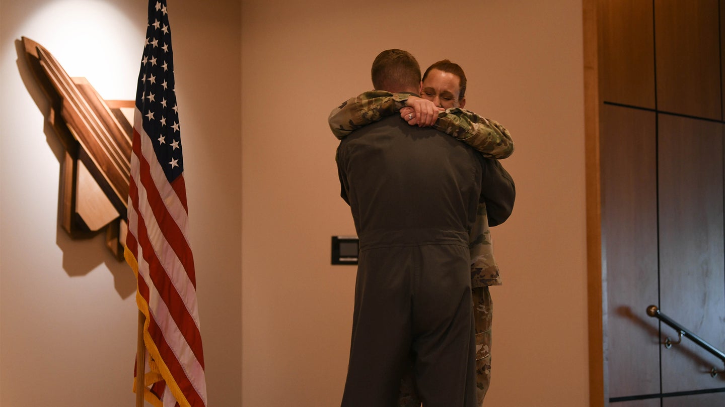 U.S. Air Force Chief Master Sgt. Kati Grabham, 325th Fighter Wing command chief, embraces her son, U.S. Air Force 2nd Lt. Cory Garcia, an air battle manager assigned to Tinker Air Force Base, Oklahoma, at Tyndall AFB, Florida, March 30, 2021. Garcia delivered the oath of enlistment to Grabham, his mother, for her last re-enlistment ceremony. (U.S. Air Force photo by Airman 1st Class Anabel Del Valle)