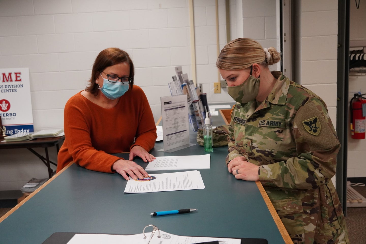 (From left) Connie Schauer, education services specialist with the 88th Readiness Division, and Chief Warrant Officer 2 Autumn Schumacker, a human resources technician with the 86th Training Division, discuss education funding options. (U.S. Army Photo by Cheryl Phillips)