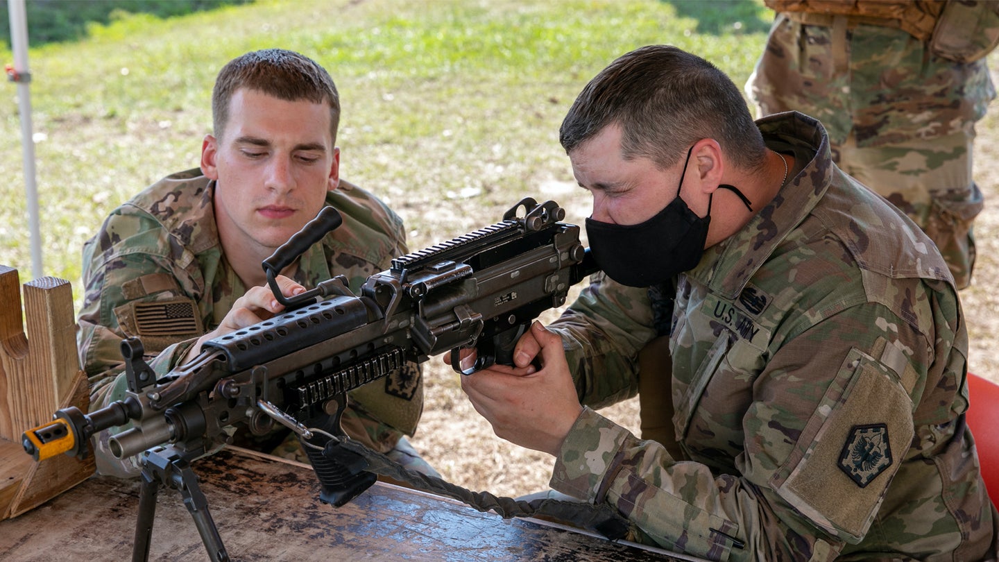 Soldiers confirm the laser for a Code 27 Small Arms Transmitter attached to an M249 machine gun during an exercise at the Joint Readiness Training Center at Fort Polk, Louisiana, Oct. 11, 2020. (U.S. Army/Sgt. Ezra Camarena, 28th Public Affairs Detachment)