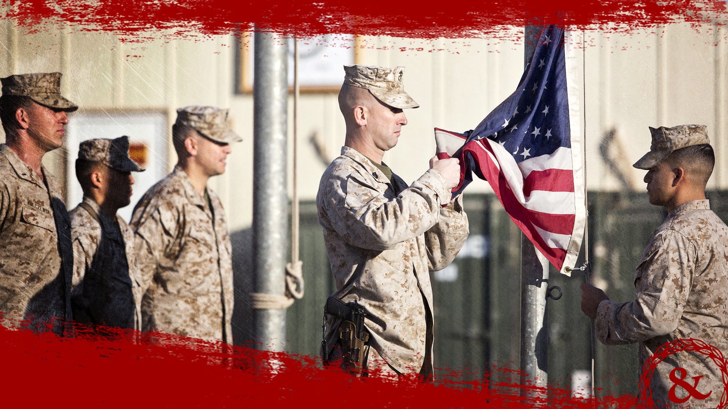 Marines and coalition forces with Regional Command (Southwest) hold a flag raising ceremony at Camp Leatherneck, Helmand province, Afghanistan, Nov. 11, 2013.  (U.S. Marine Corps photo by Sgt. Demetrius Munnerlyn)