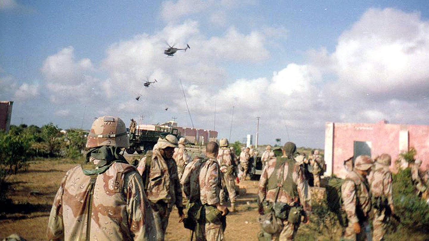 Army soldiers of Company B, 2nd Battalion, 14th Infantry Regiment, watch helicopter activity over Mogadishu, Oct. 3, 1993. (U.S. Army)