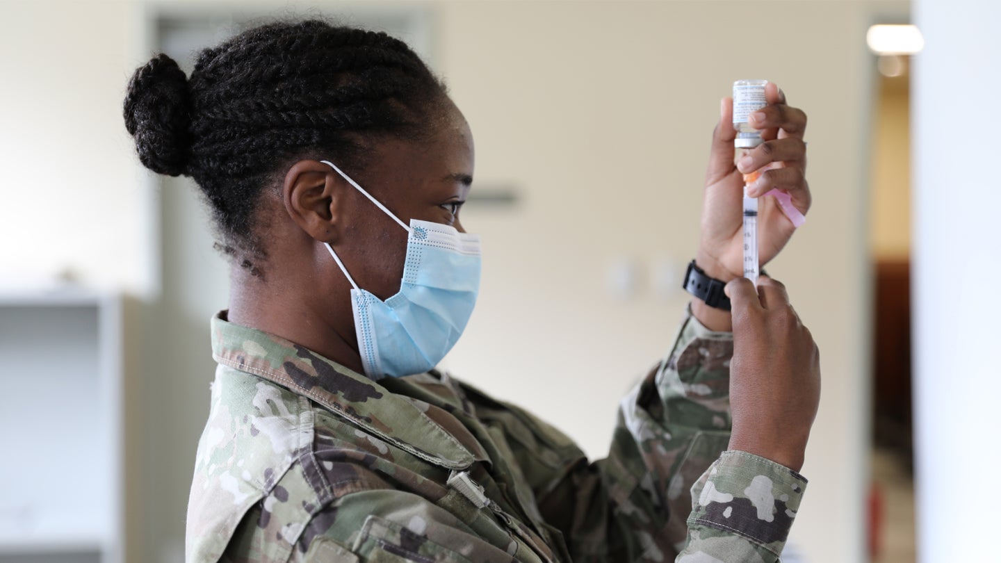 Pfc. Shaniah Edwards, Medical Detachment, prepares to administer the Moderna COVID-19 vaccine to soldiers and airmen at the Joint Force Headquarters, February 12, 2021. (U.S. Army National Guard/Sgt. Leona C. Hendrickson)
