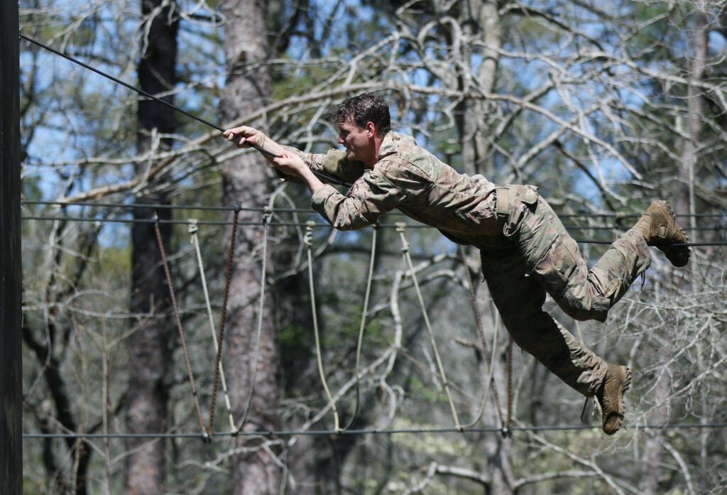 A student assigned to the U.S. Army John F. Kennedy Special Warfare Center and School climbs across a rope during the evasion phase of Survival Evasion Resistance and Escape Level-C training (SERE) at Camp Mackall, North Carolina, March 21, 2020. Soldiers in SERE underwent intensive training in support of the Code of the Conduct, and were taught survival fieldcraft skills, techniques of evasion, resistance to exploitation and resolution skills along with critical life saving techniques for austere conditions that are key to survival and the ability to return with honor. (U.S. Army photo by K. Kassens)
