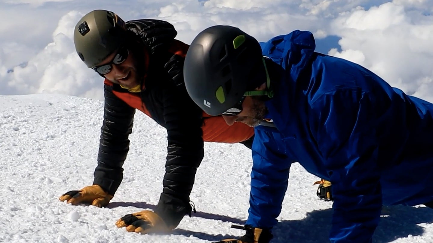 A mountaineer leads two of his fellow mountaineering teammates in celebratory pushups after they reach the 20,310-foot peak of Alaska's Denali in June, 2021. The group is hiking North America's tallest mountain peak as part of a resiliency-building challenge. (Screenshot via video by Air Force Lt. Col. Rob Marshall)