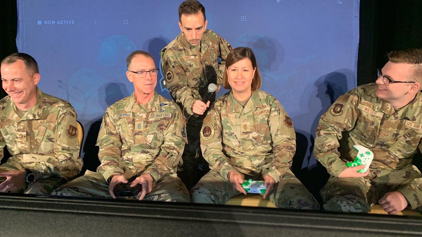 Chief Master Sgt. of the Air Force JoAnne Bass and Chief Master Sgt. of the Space Force Roger Towberman duke it out with younger airmen while playing Mario Kart at an Air Force Gaming tournament on July 26, 2021 (Facebook / CMSAF JoAnne Bass)