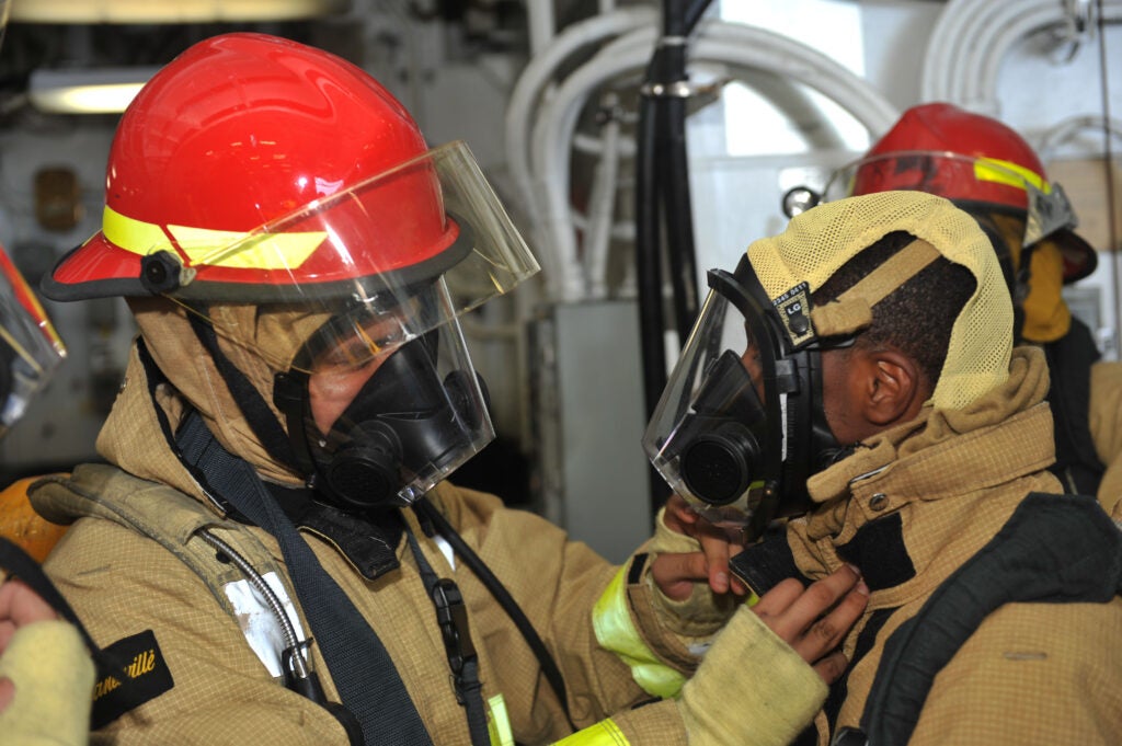 Sailors attached to repair locker 1H prepare to fight a simulated fire during a main space fire drill aboard the forward-deployed amphibious assault ship USS Bonhomme Richard (LHD 6). Bonhomme Richard, commanded by Capt. Daniel Dusek, is the lead ship of the only forward-deployed amphibious ready group.  (U.S. Navy photo by Mass Communication Specialist Seaman Adam D. Wainwright/Released