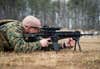 U.S. Marine Staff Sgt. Gregory Ashton with the Marine Security Augmentation Unit (MSAU), engages his target during a weapons field test of the M27 Infantry Automatic Rifle at Marine Corps Base Quantico, Va., Feb. 21, 2014. The MSAU Marines conducted the live-fire range in order to familiarize themselves with the new weapons system. (U.S. Marine Corps photo by Staff Sgt. Ezekiel R. Kitandwe/Released)