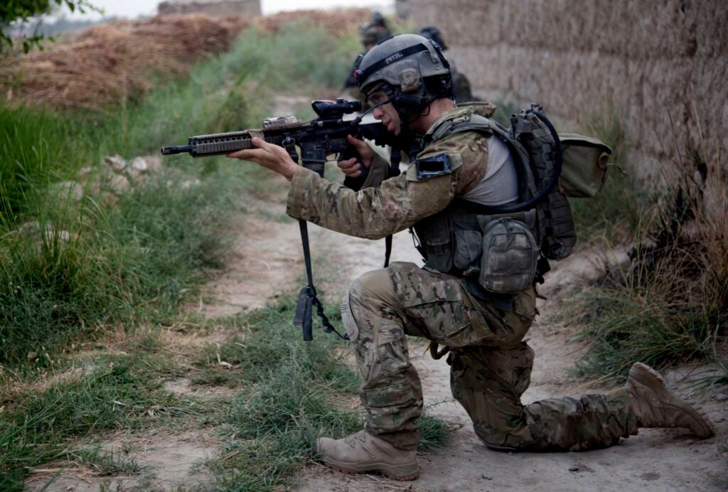 A member of the Afghan-international security force pulls security on a compound in Kandahar province Zhari District, Afghanistan, June 24. (U.S. Army photo by Spc. Christian Palermo)