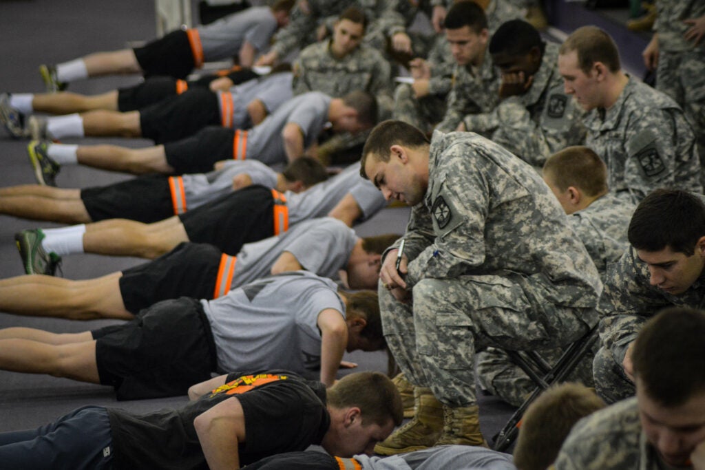 Clemson University Reserve Officers' Training Corps cadets grade fellow cadets during the pushup event of the Army Physical Fitness Test Jan. 15, 2015. U.S. Army Soldiers must pass the APFT at least once every six months. It consists of two minutes of pushups, two minutes of situps and a timed two-mile run. (U.S. Army photo by Sgt. Ken Scar)