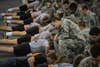 Clemson University Reserve Officers' Training Corps cadets grade fellow cadets during the pushup event of the Army Physical Fitness Test Jan. 15, 2015. U.S. Army Soldiers must pass the APFT at least once every six months. It consists of two minutes of pushups, two minutes of situps and a timed two-mile run. (U.S. Army photo by Sgt. Ken Scar)
