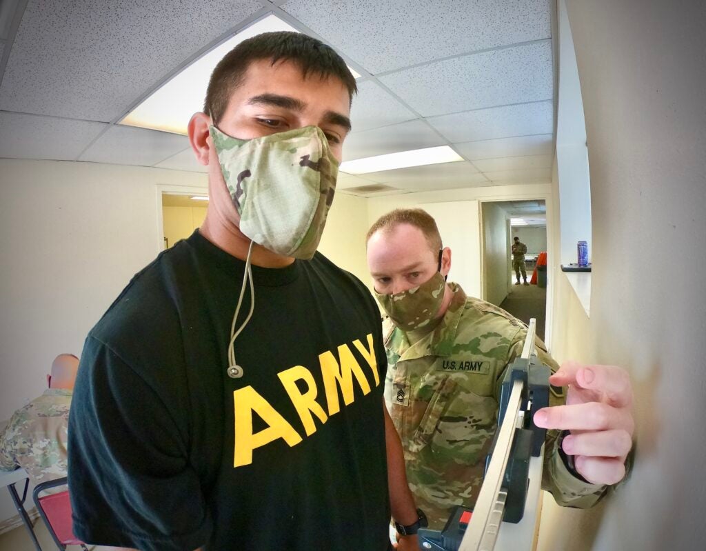 Sgt. 1st Class Charles Arrison (right), a training management noncommissioned officer-in-charge, assigned to the operations section, Headquarters and Headquarters Company, 76th Operational Response Command, checks the weight of Army Reserve Spc. Alan Lopez, a patient administration specialist, assigned to Company A, 228th Combat Support Hospital, 807th Medical Command (Deployment Support) at Camp Williams, Utah, April 13, during the check-in process for the Joint Command Best Warrior Competition for the 76th ORC and the 807th MC (DS). The competition begins today and will end on Saturday, April 17. (Official U.S. Army Reserve photo by Sgt. 1st Class Brent C. Powell)