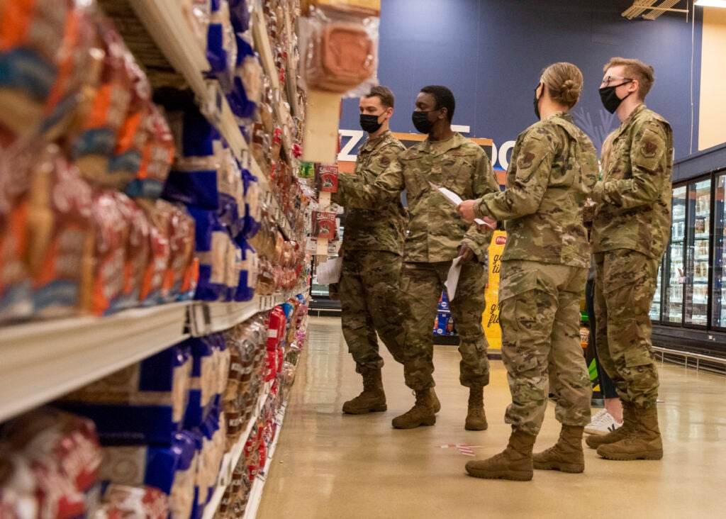 U.S. Airmen and Soldiers look at the nutritional labels on different loaves of bread during a Health Promotion-led Commissary tour at Joint Base Elmendorf-Richardson, Alaska, April 19, 2021. Health Promotion strives to promote health and wellness for all military members, their dependents, and Department of Defense civilians through community and group events to improve the health, mission readiness and productivity of the military community.