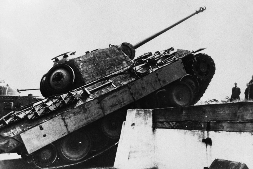 A German Panther tank taking a hurdle during a test drive before going into action on July 25, 1944. These tanks, the latest production in Germany are equipped with a 7.5 cm cannon, a defence weapon for close combat and three machine guns. (AP Photo)