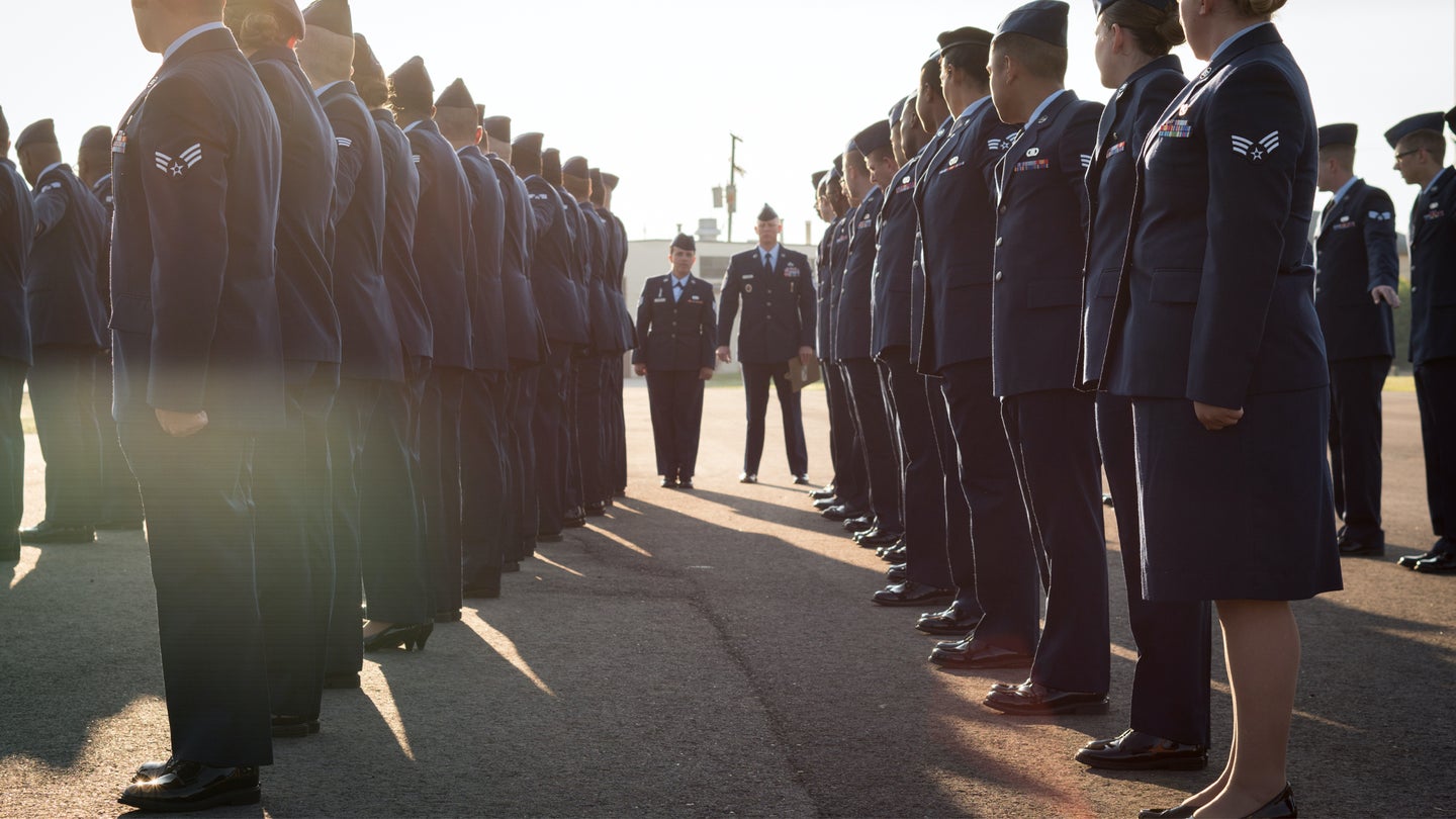 Airman Leadership School class 18-6 “dress” to their right before a blues inspection at Barksdale Air Force Base, La., Aug. 2, 2018. During the inspection, Senior Master Sgt. Zach McKinney, ALS NCO in-charge, and Staff Sgt. Martha Munera, ALS class lead, look over the service dress uniform of each member of the class. (U.S. Air Force photo by Senior Airman Philip Bryant)