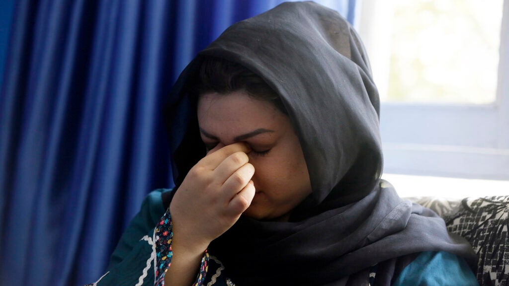 Zarmina Kakar a women's rights activist cry during an interview with The Associated Press in Kabul, Afghanistan, Friday, Aug. 13, 2021. Kakar was a year old when the Taliban entered Kabul the first time in 1996, and recalled a time when her mother took her out to buy her ice cream, back when the Taliban ruled. Her mother was whipped by a Taliban fighter for revealing her face for a couple of minutes.   “Today again, I feel that if Taliban come to power, we will return back to the same dark days,” she said.(AP Photo/Mariam Zuhaib)