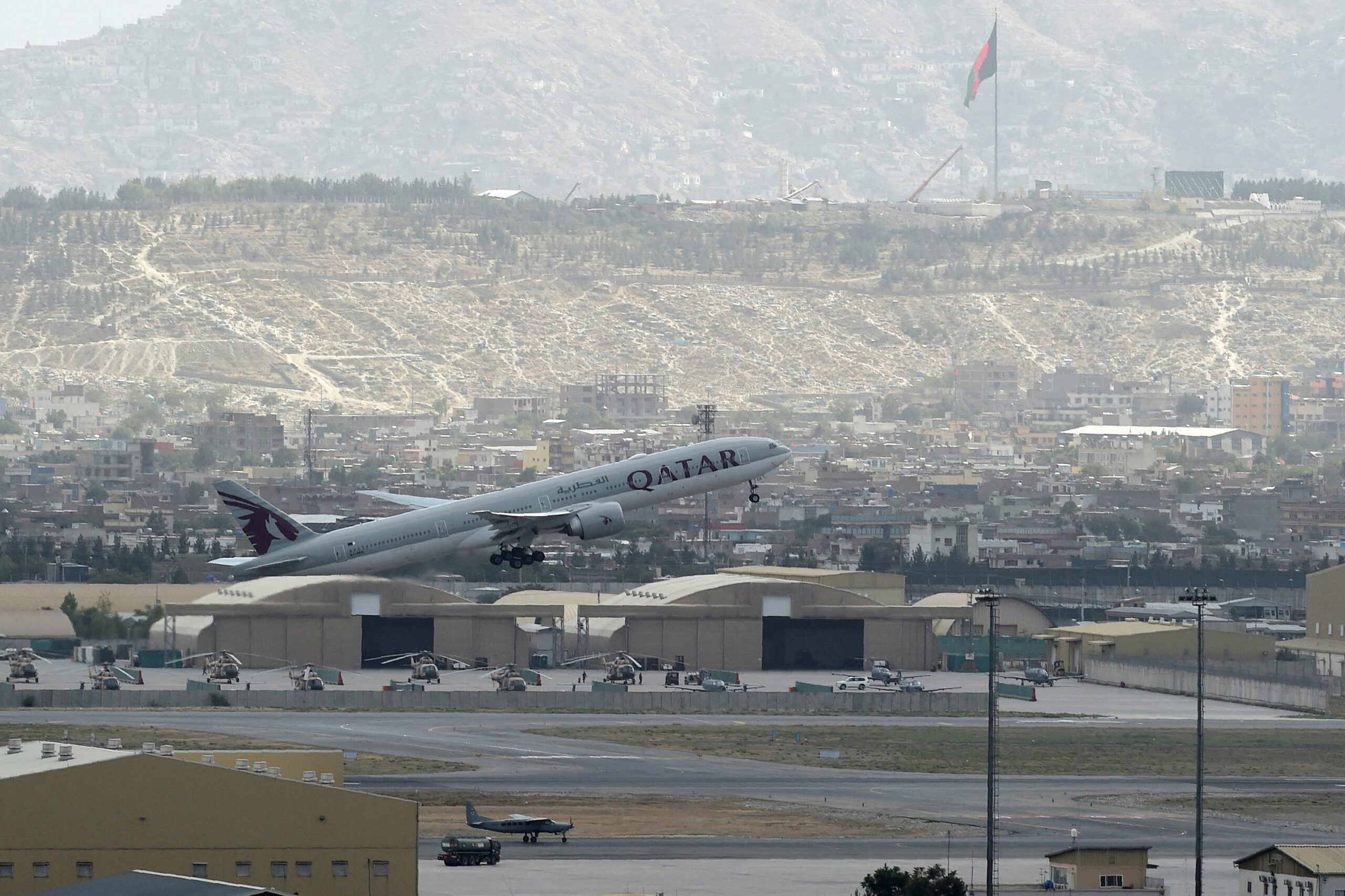 This picture taken on August 14, 2021 shows a Qatar Airways aircraft taking-off from the airport in Kabul. (Photo by Wakil KOHSAR / AFP) (Photo by WAKIL KOHSAR/AFP via Getty Images)