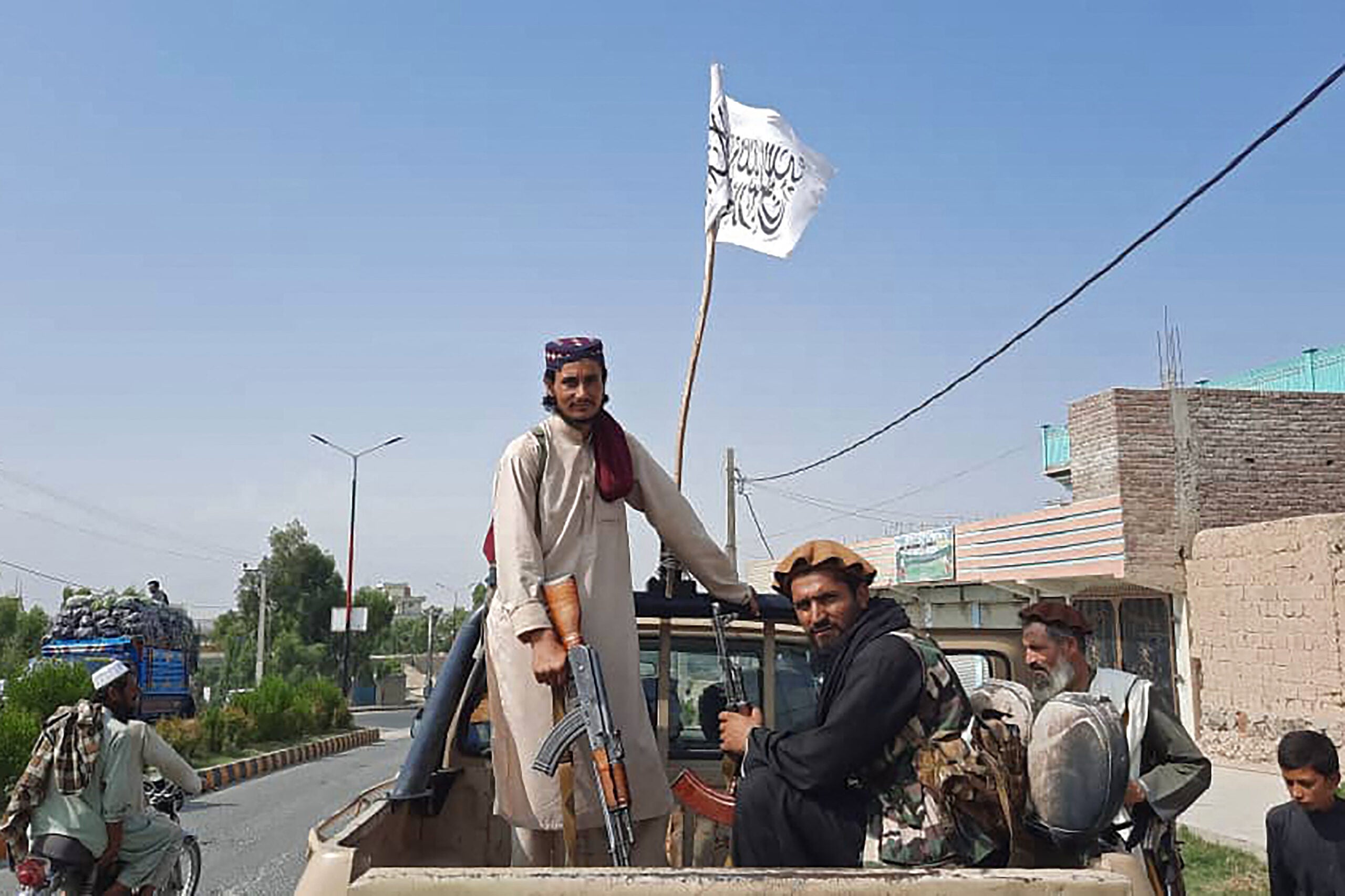 TOPSHOT - Taliban fighters drive an Afghan National Army (ANA) vehicle through the streets of Laghman province on August 15, 2021. (Photo by - / AFP) (Photo by -/AFP via Getty Images)