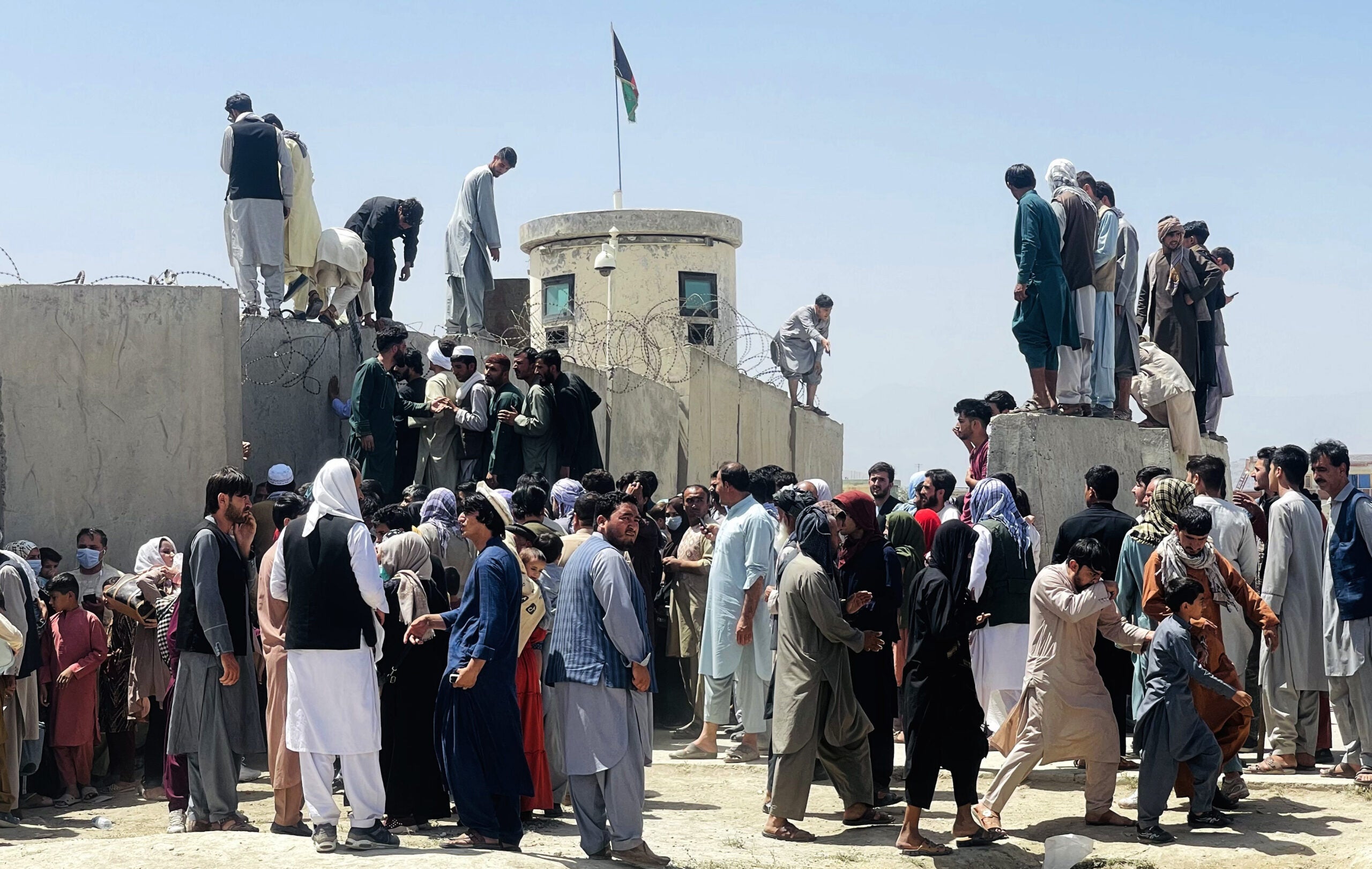 KABUL, AFGHANISTAN-AUGUST 16: Thousands of Afghans rush to the Hamid Karzai International Airport as they try to flee the Afghan capital of Kabul, Afghanistan, on August 16, 2021. (Photo by Haroon Sabawoon/Anadolu Agency via Getty Images)
